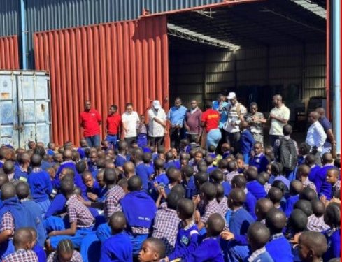 Students gathered at a Dragon Group community donation event