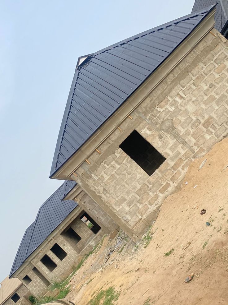 Row of new block houses with dark box-profile steel roofs