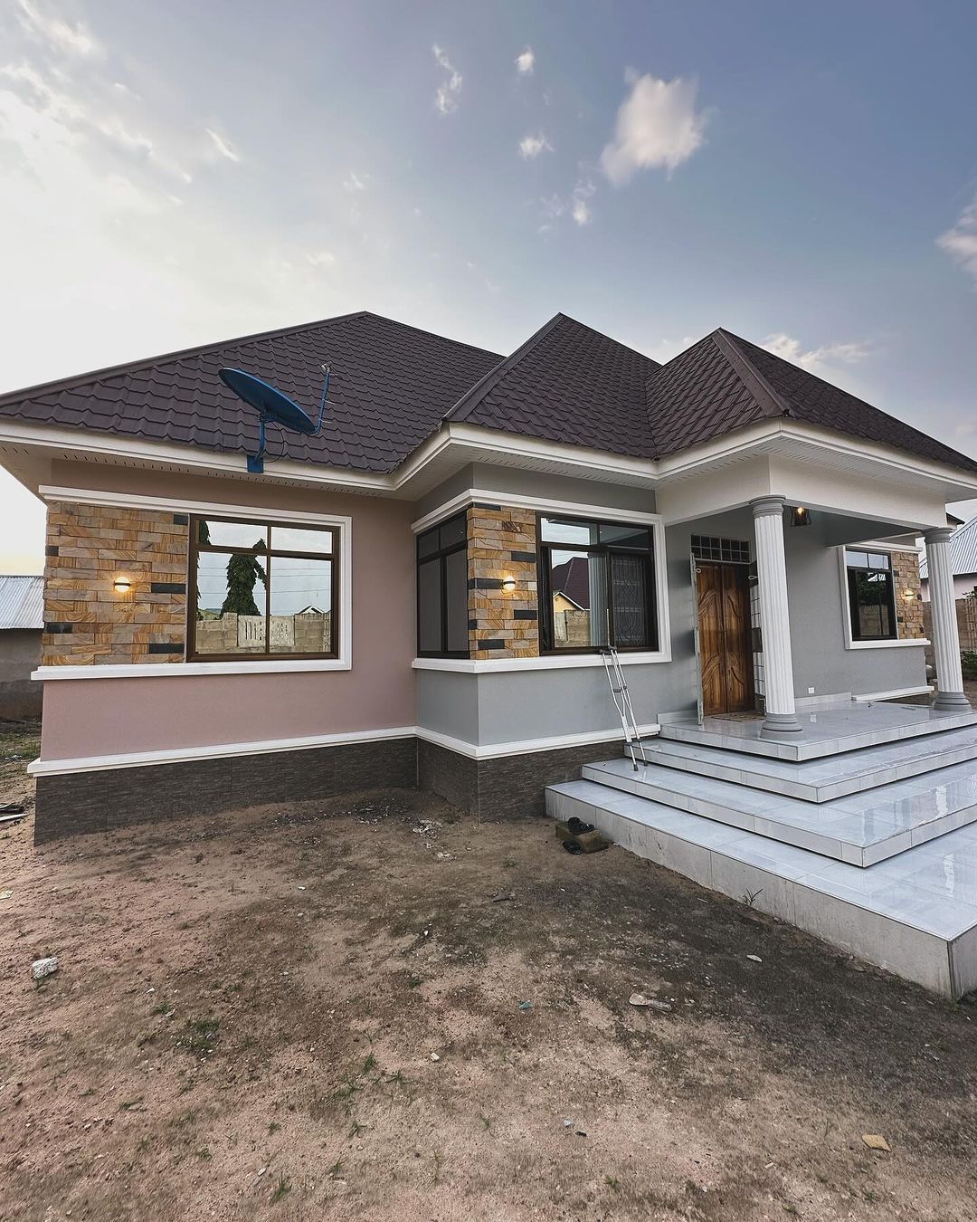 Completed family home with a brown tile-profile steel roof and a tiled veranda